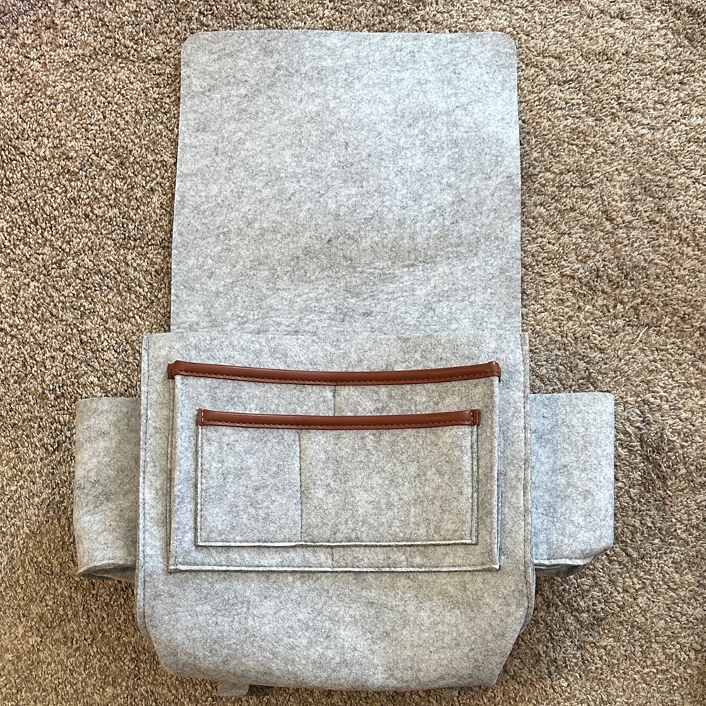 Hanging grey felt organizer with adjustable straps and two cord holes